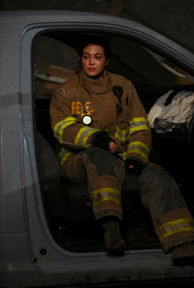 Gabriela sits in a damaged truck after a long day - Fire Country Season 2 Episode 7