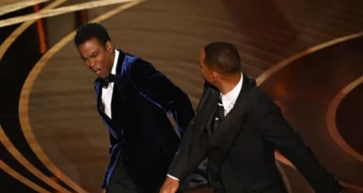 US actor Will Smith (R) slaps US actor Chris Rock
