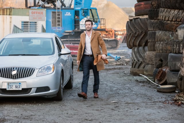 Mick strolls through a junkyard - Supernatural Season 12 Episode 17