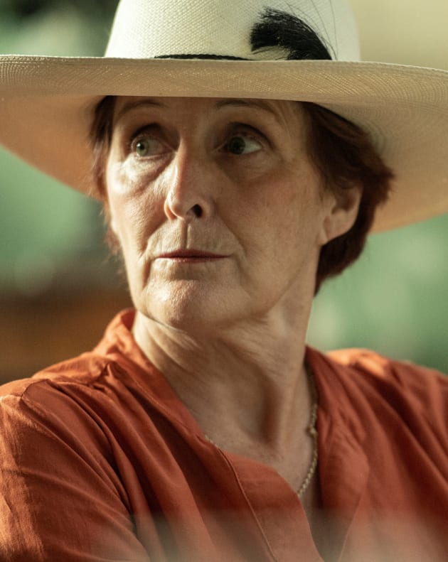 Carolyn Sitting at A Table - Killing Eve Season 4 Episode 4