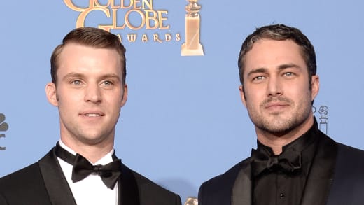 Jesse Spencer (L) and Taylor Kinney pose in the press room during the 71st Annual Golden Globe Awards 