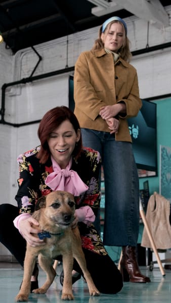 Elsbeth petting a dog - Elsbeth - Season 1 Episode 8