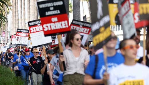 Striking WGA (Writers Guild of America) members picket with striking SAG-AFTRA members outside Netflix studios