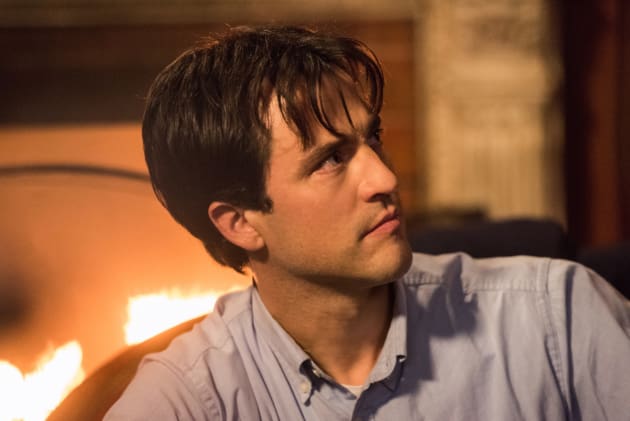 Gavin sits near the fire - Supernatural Season 12 Episode 13